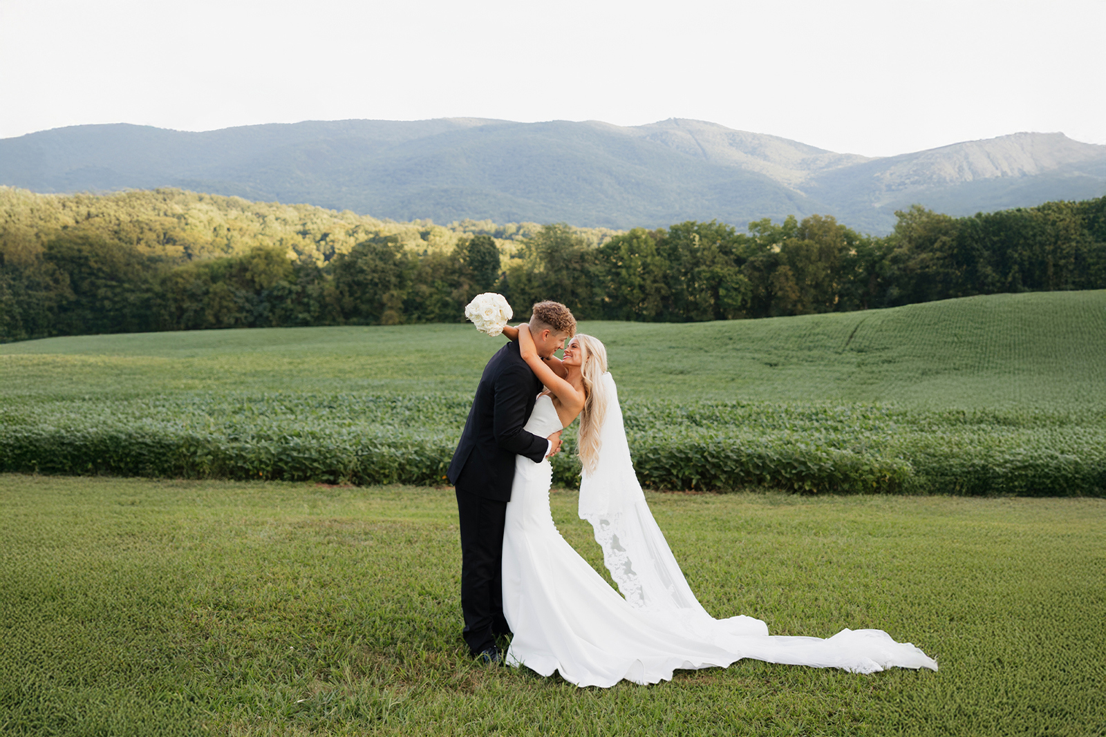 A couple in the mountain field at golden hour