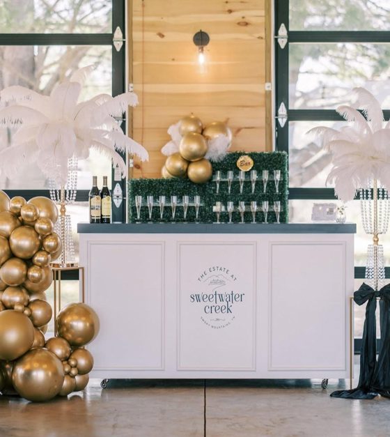 The bar set up in the pavilion, glasses lined along the back