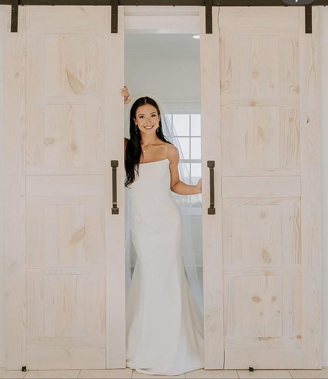 A bride in the sliding barn doorway