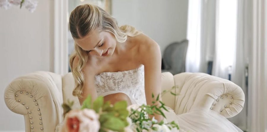 A bride waiting in the suite, florals in the foreground