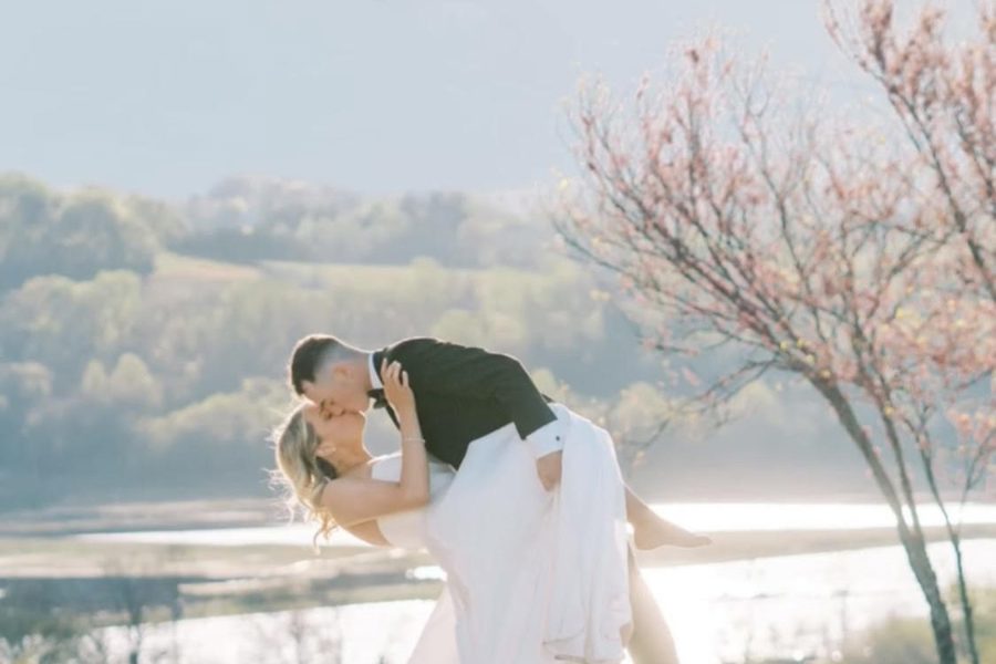 A couple by the water below the estate in spring