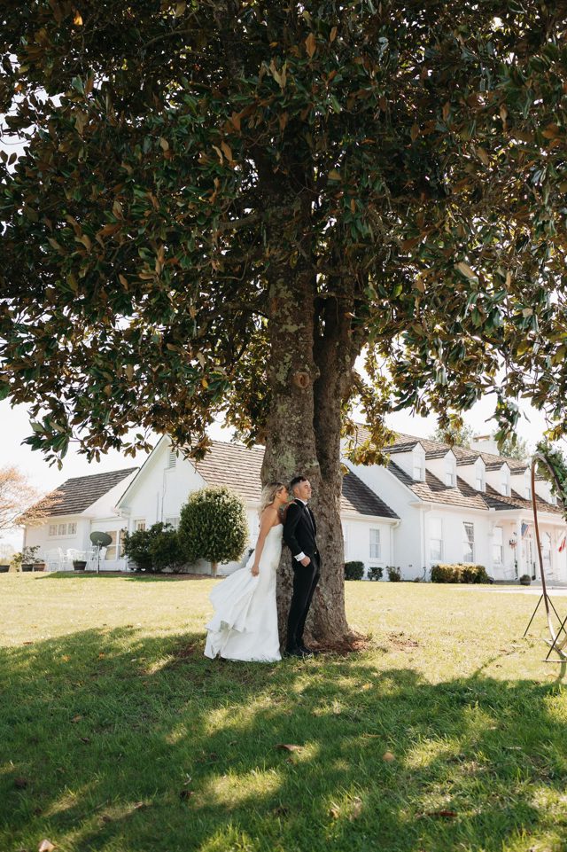 A couple beneath the magnolia at the ceremony site