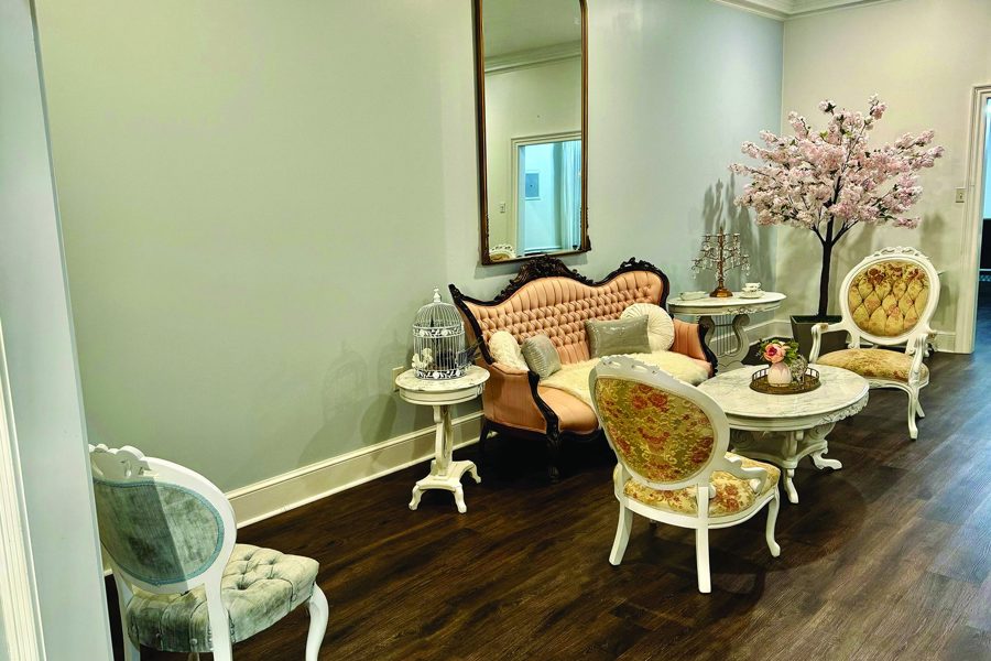 A sitting room on the property, gilt mirrors and antique chairs