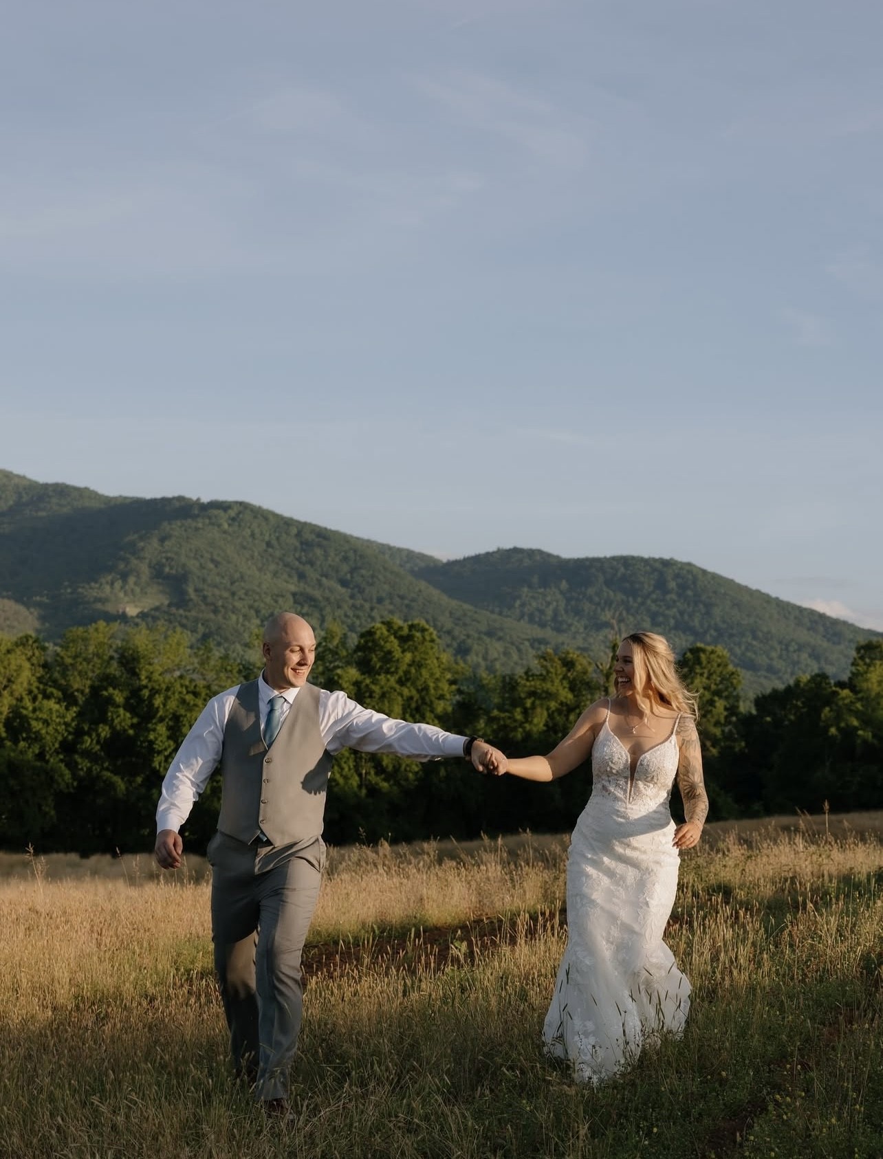 A couple in the mountain field at golden hour